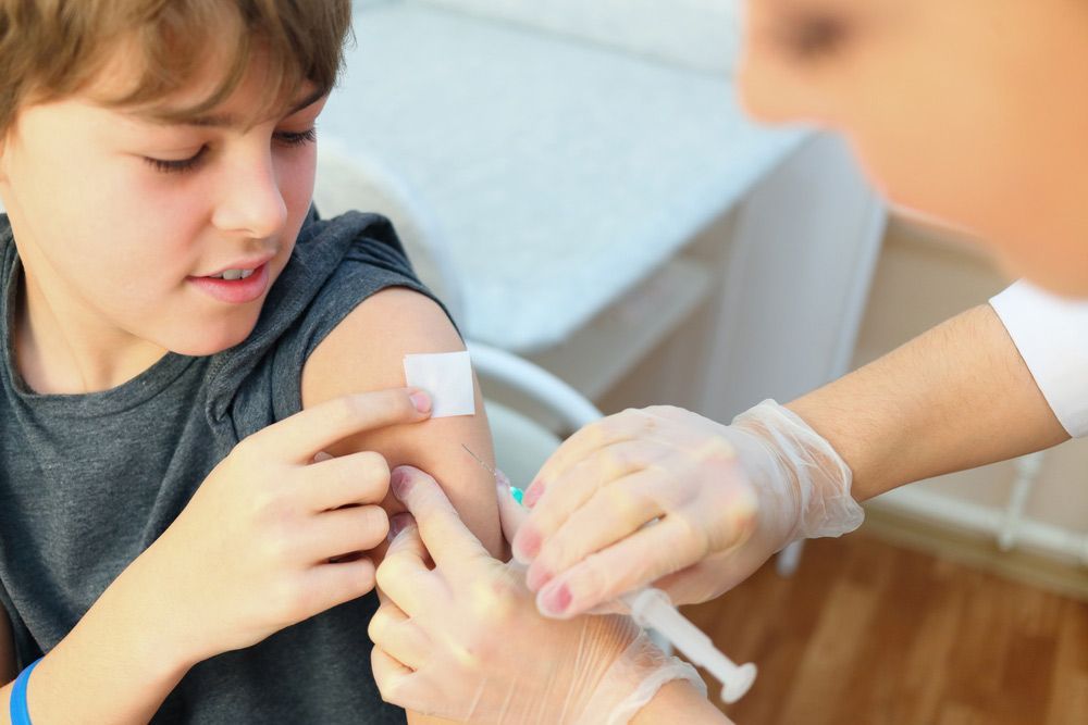 A Young Boy is Getting an Injection in His Arm — Mount Archer Medical Centre in Berserker, QLD