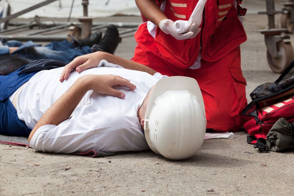 A Man is Laying on the Ground Having a First Aid — Mount Archer Medical Centre in Berserker, QLD