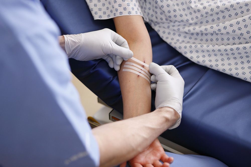 A Doctor is Putting a Bandage on a Patient's Arm — Mount Archer Medical Centre in Berserker, QLD