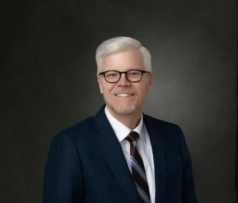 A lake in the middle of a forest with trees in the background