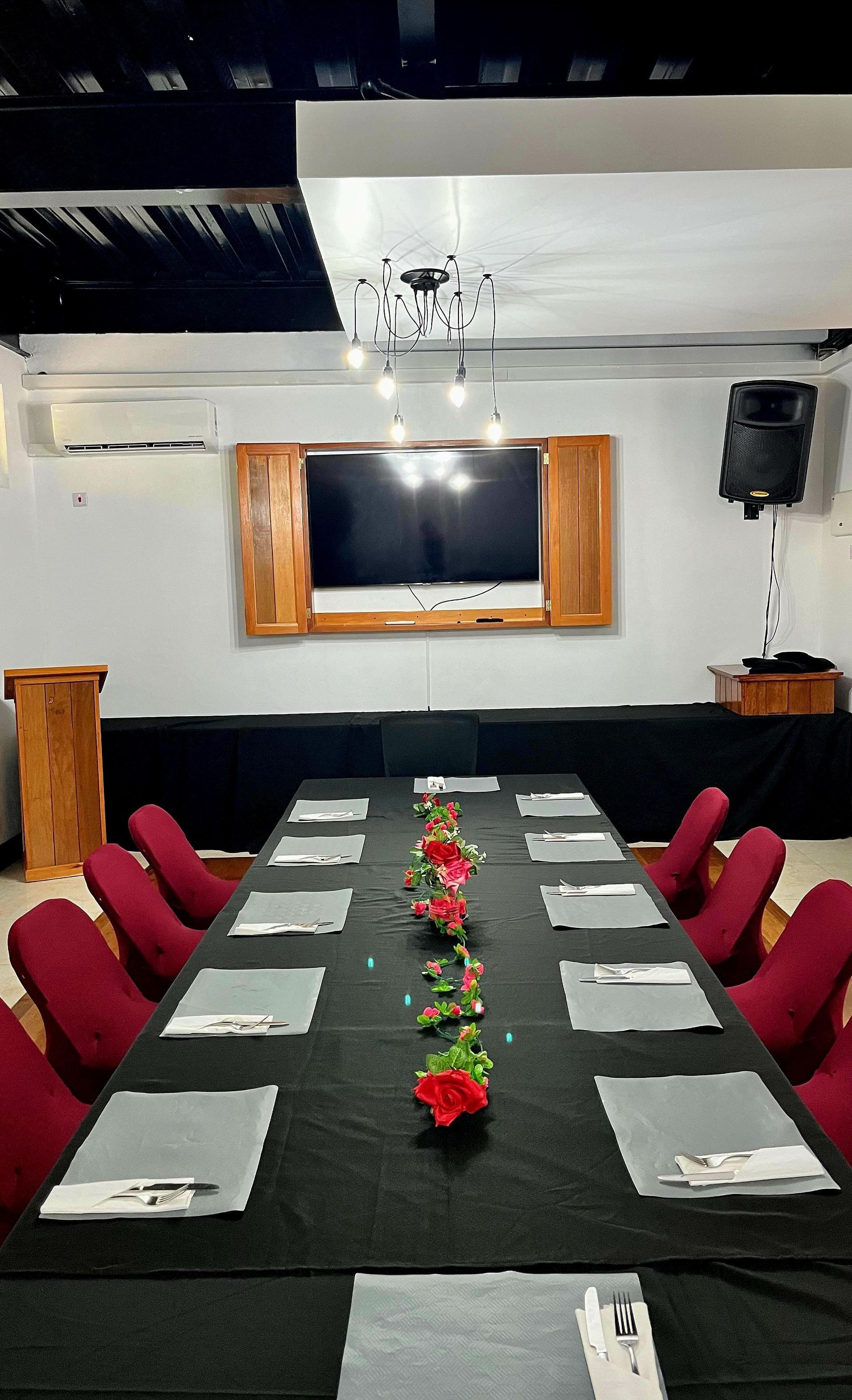 A conference room with a long table and chairs set up for a meeting.
