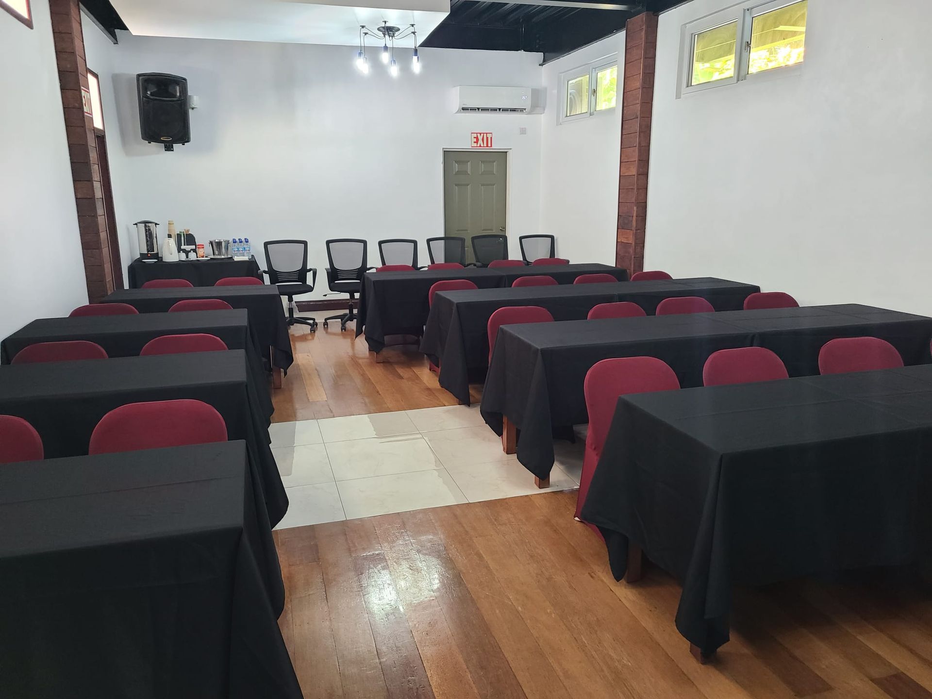 A conference room with rows of tables and chairs