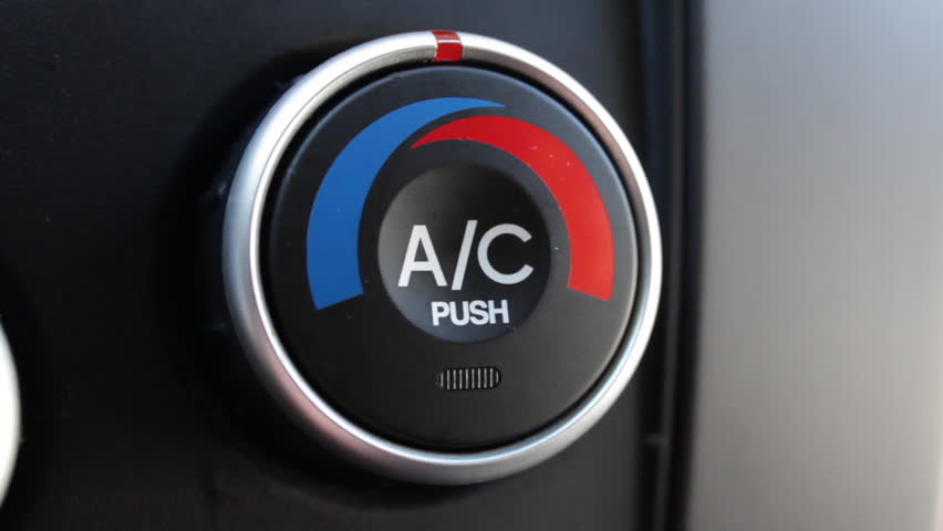 A close up of an a/c button in a car
