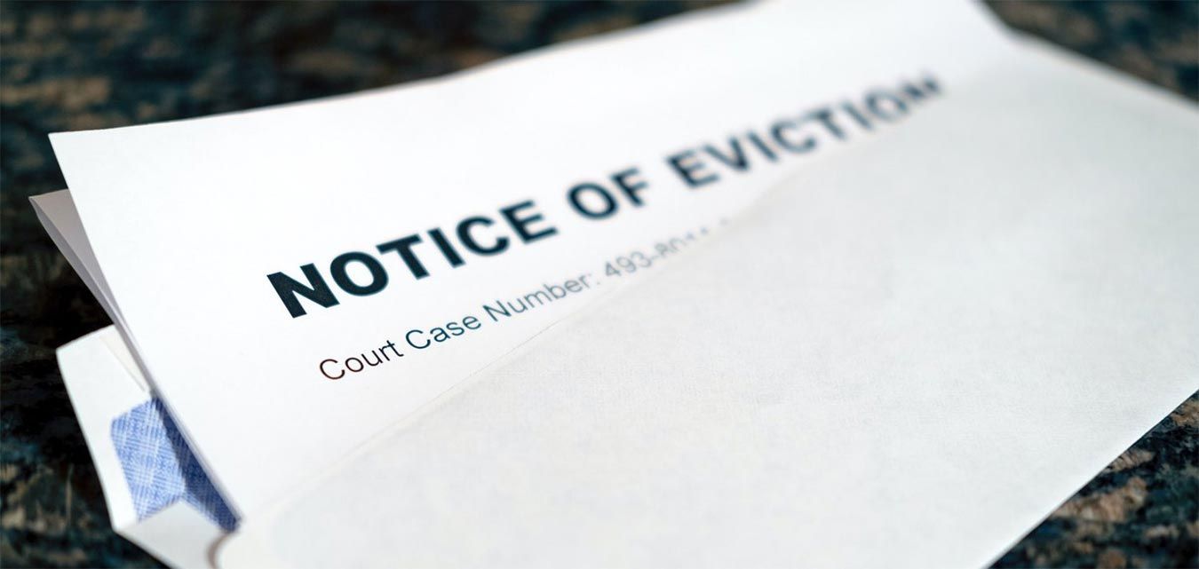 A notice of eviction is sitting on top of an envelope.