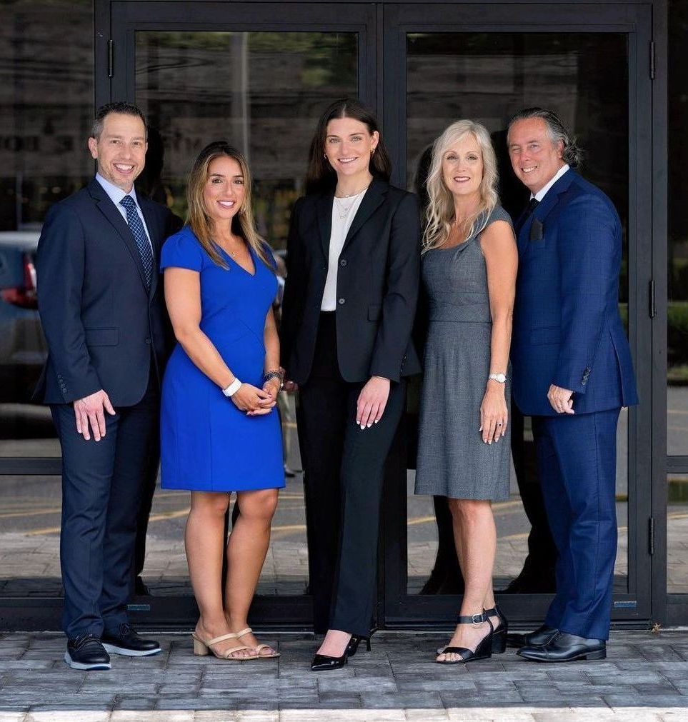 A group of people are posing for a picture in front of a building.