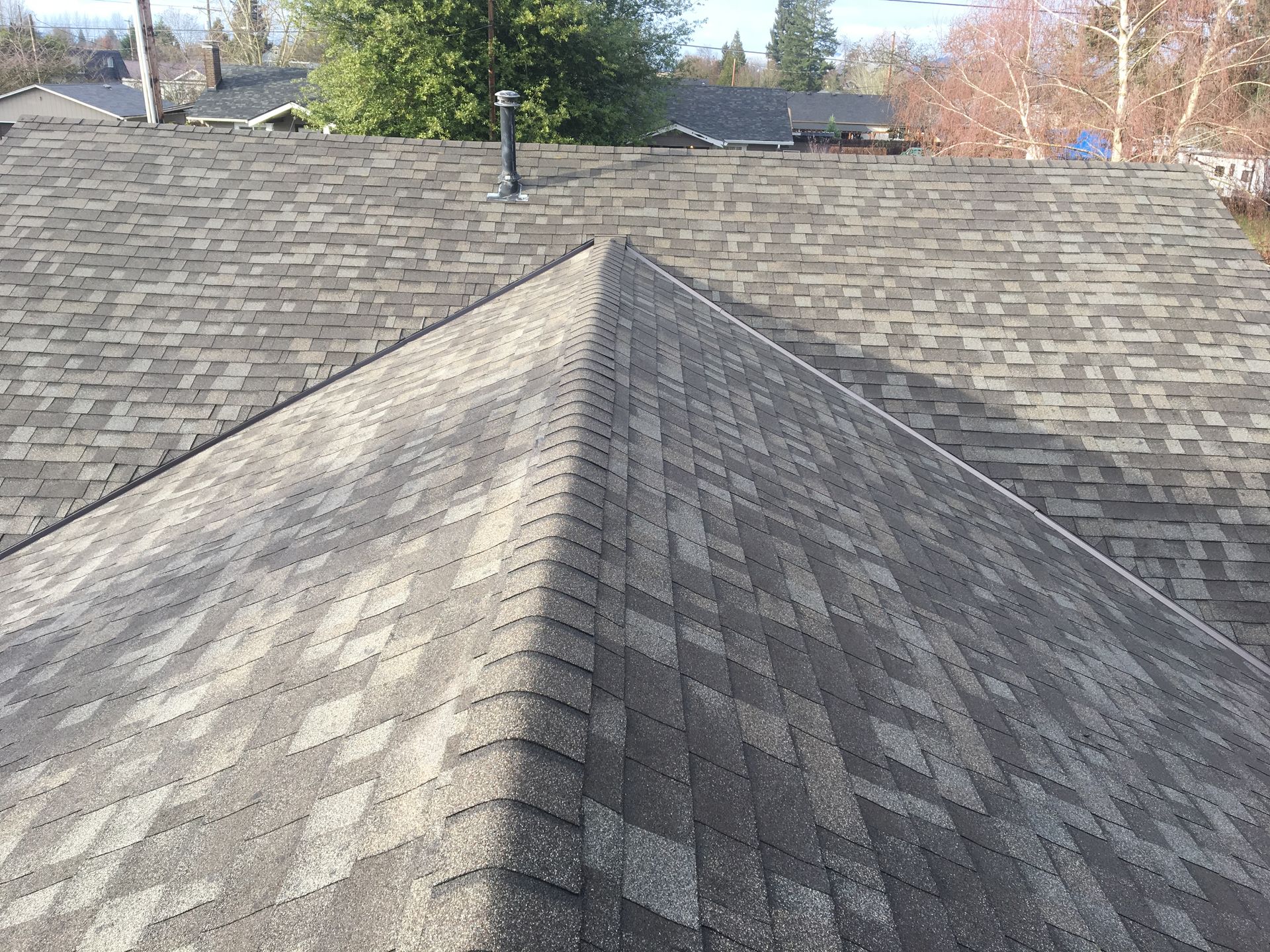 A close up of a roof with a chimney on it.