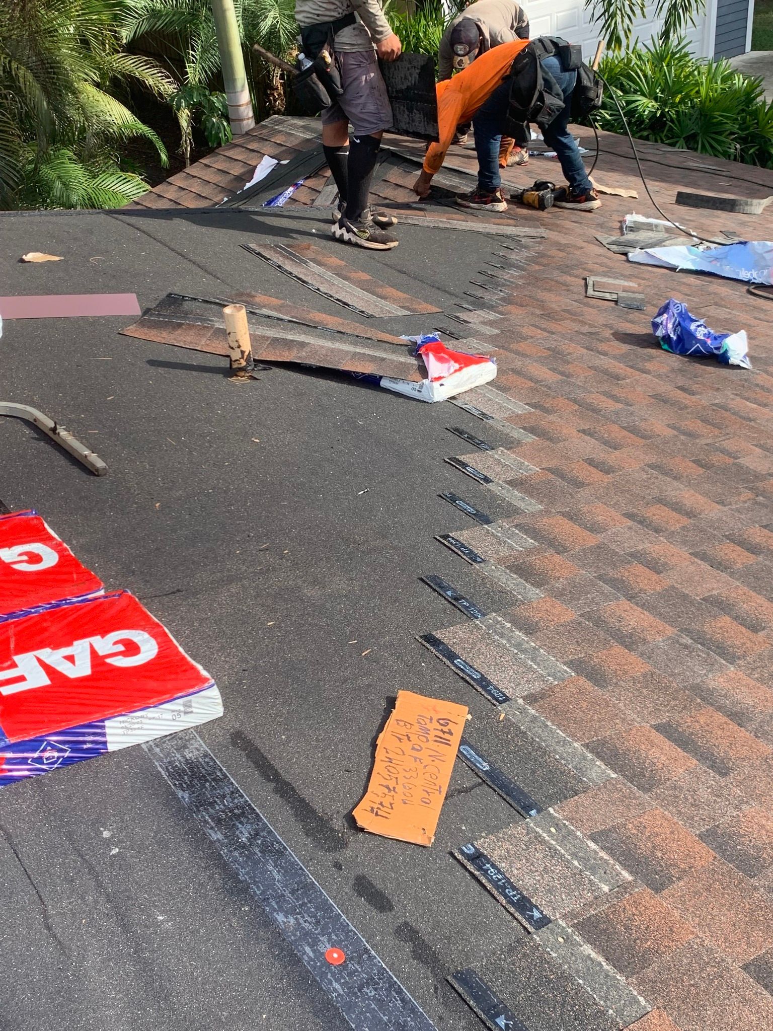 A group of people are working on a roof.