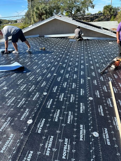 A group of people are working on a roof.