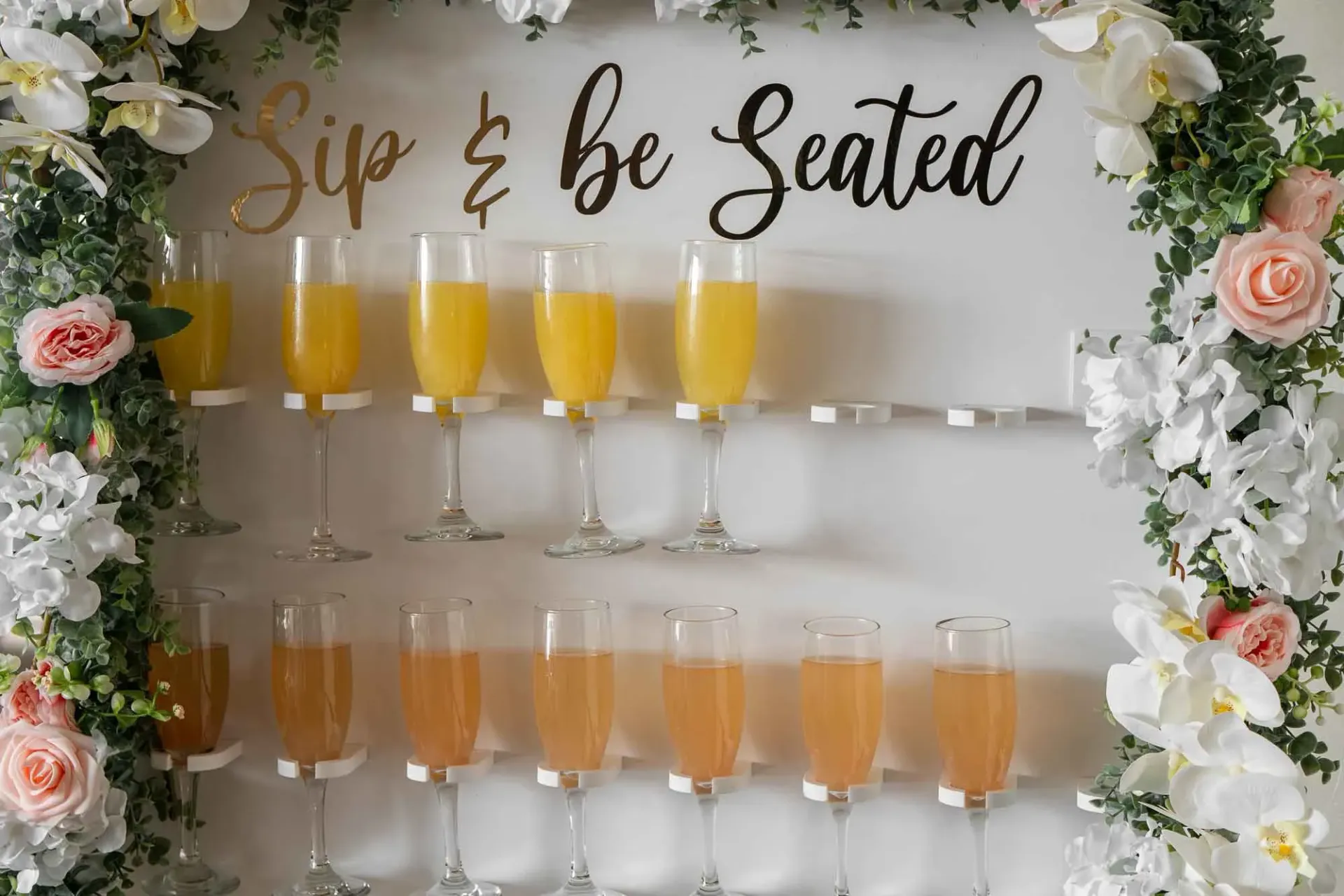 A row of champagne glasses sitting on top of a shelf.