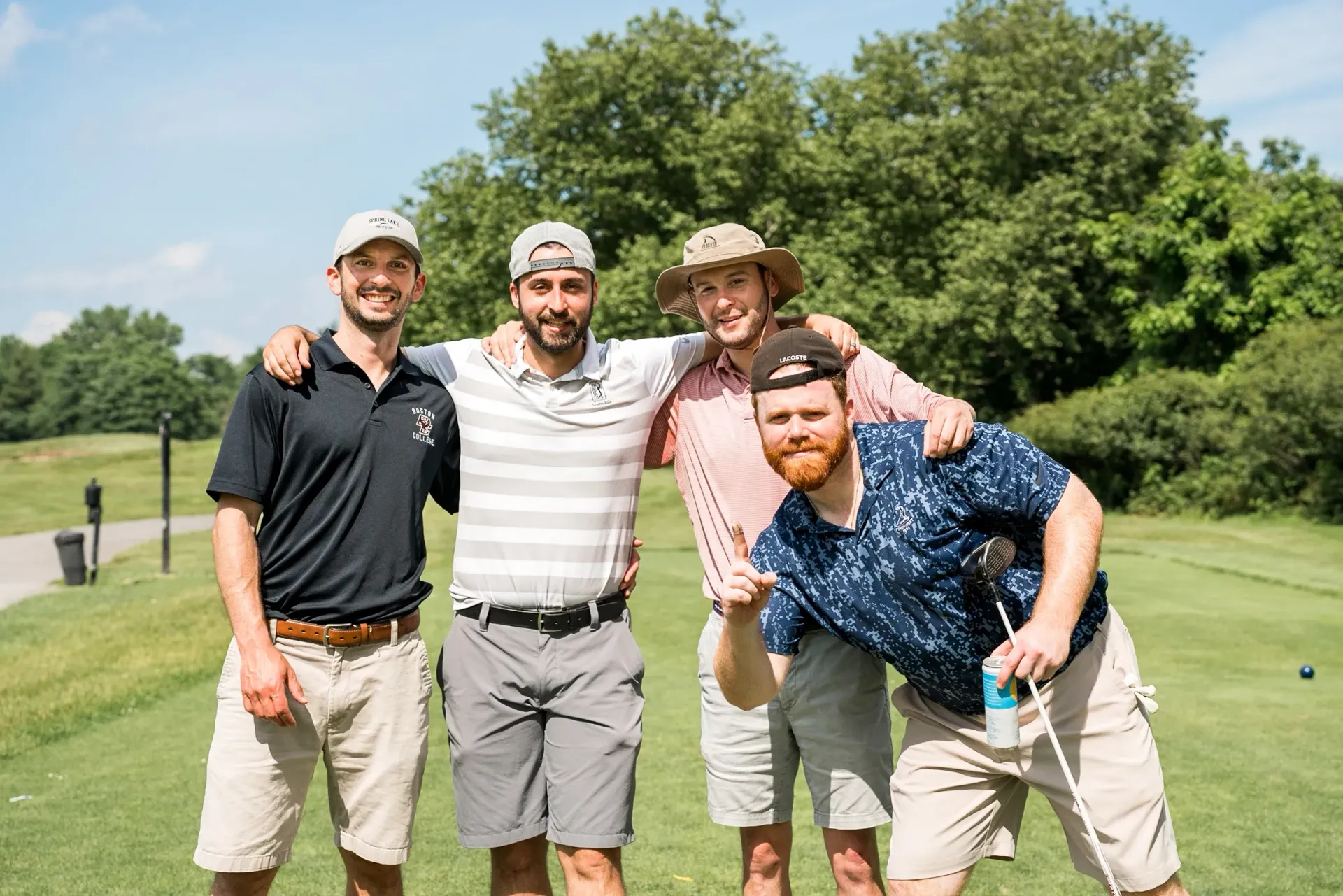 A group of men are posing for a picture on a golf course.
