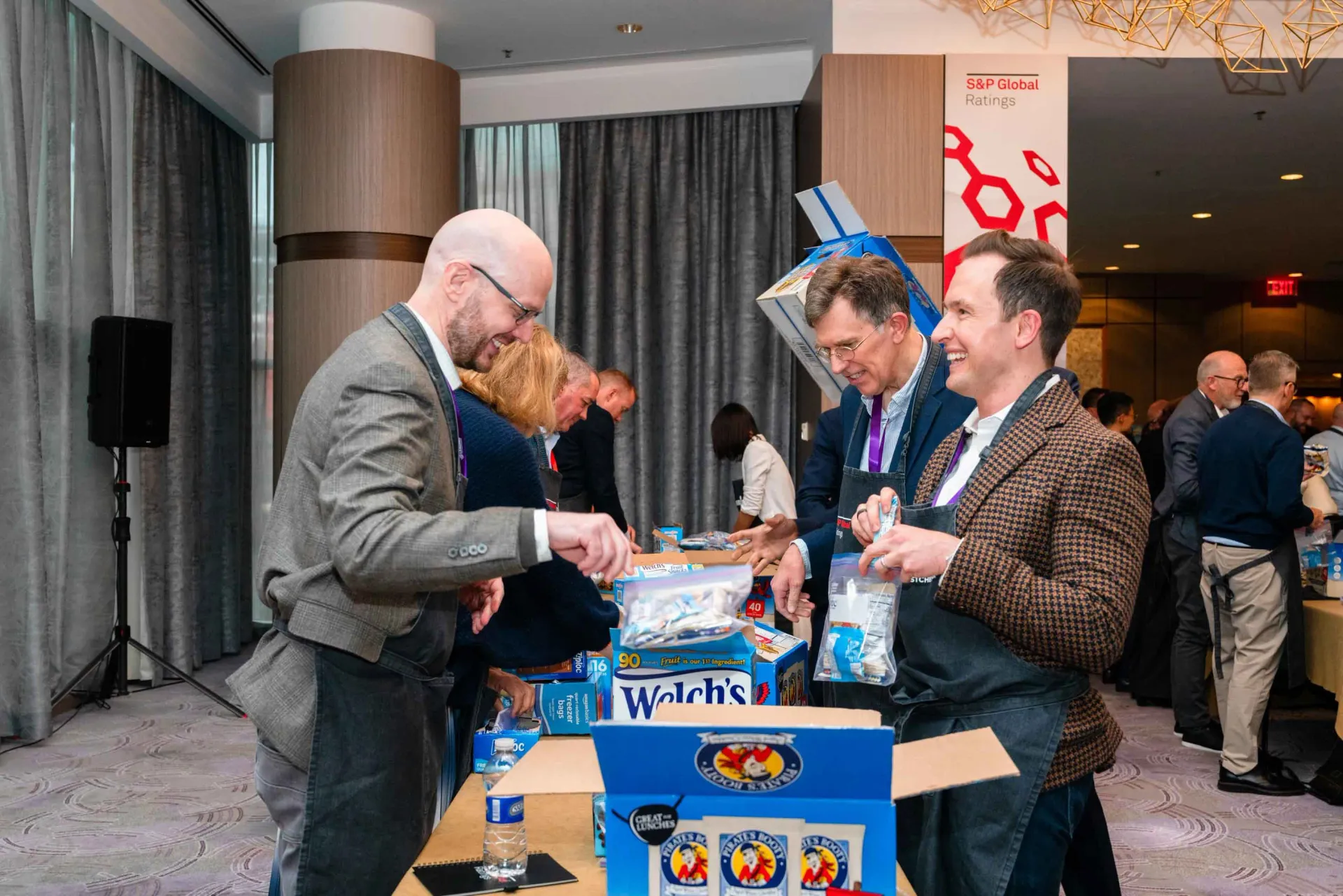 A group of men are standing around a table in a room.