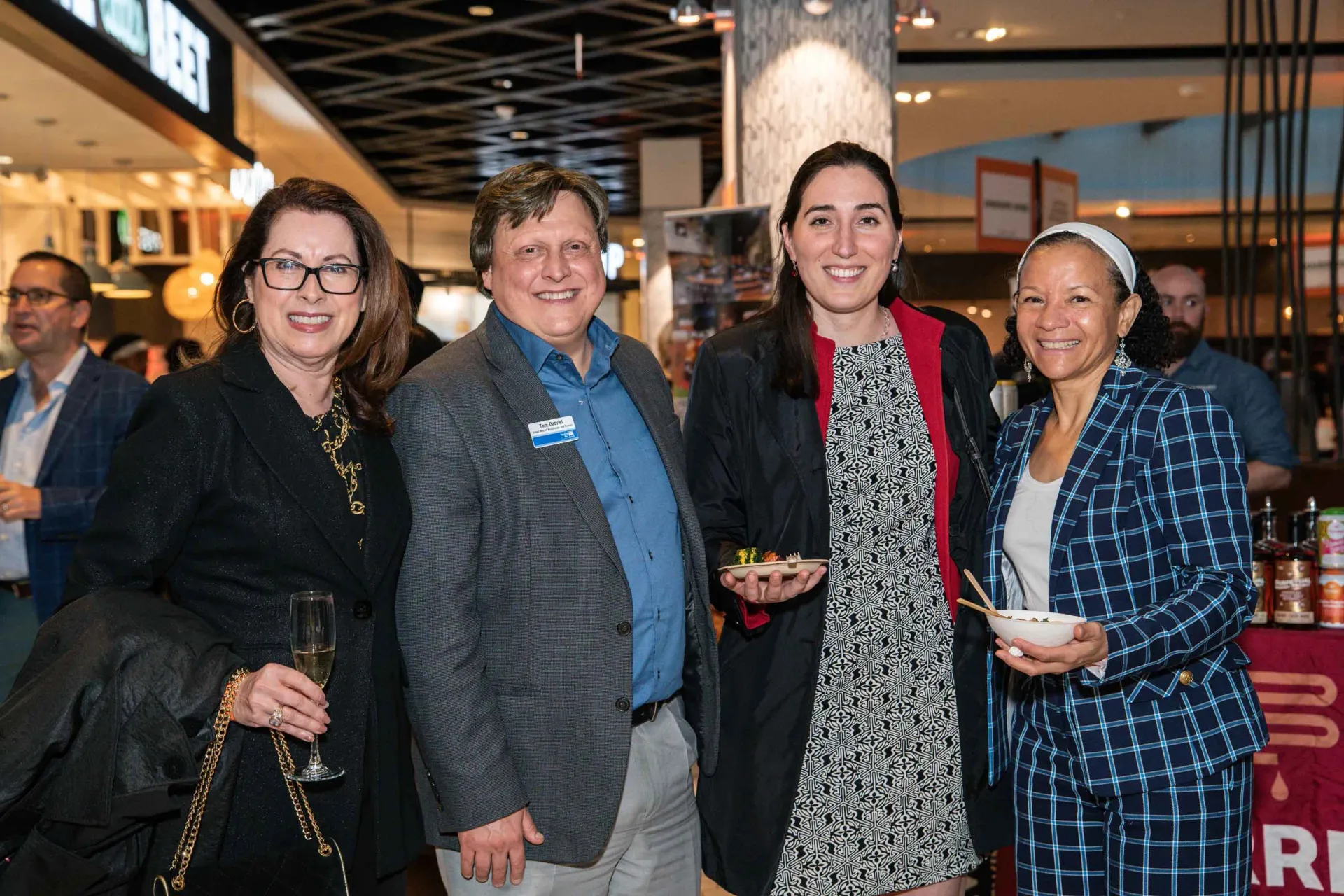 A group of people are posing for a picture in a restaurant.