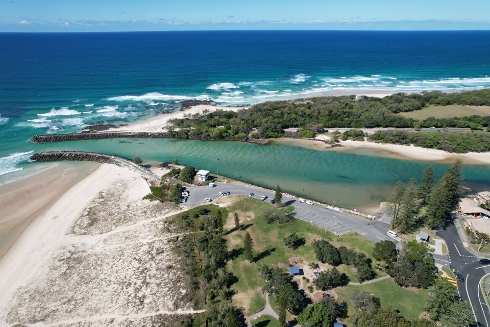 An Aerial View Of A Beach With A River Running Through It — Infinity Kitchens & Cabinets in Kingscliff, NSW