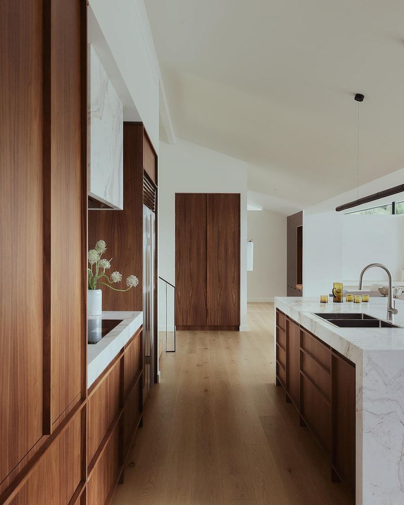A Kitchen With Wooden Cabinets And A White Counter Top — Infinity Kitchens & Cabinets in Alstonville, NSW