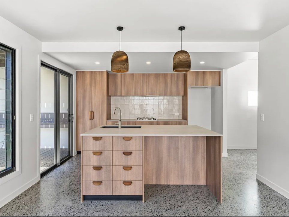 A Kitchen With A Black Refrigerator And White Cabinets — Infinity Kitchens & Cabinets in Alstonville, NSW