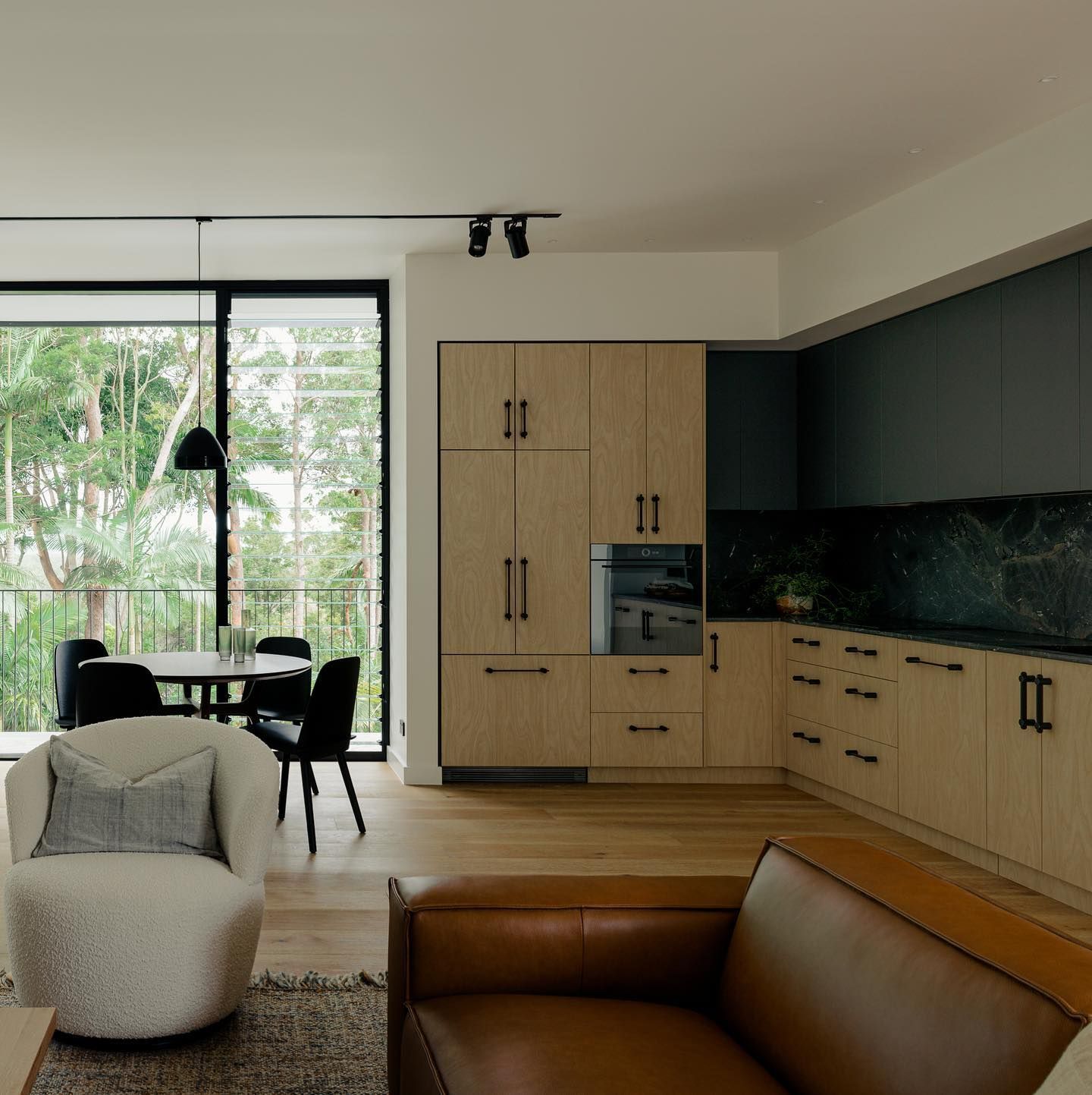 A Bathroom With A White Bathtub And Black Tiles — Infinity Kitchens & Cabinets in Alstonville, NSW