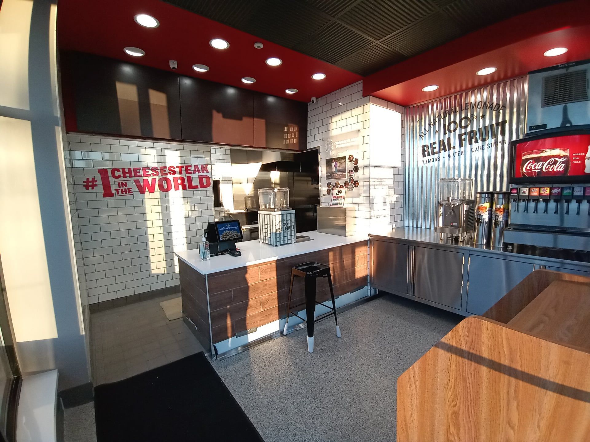 A restaurant with a coca cola sign on the wall.