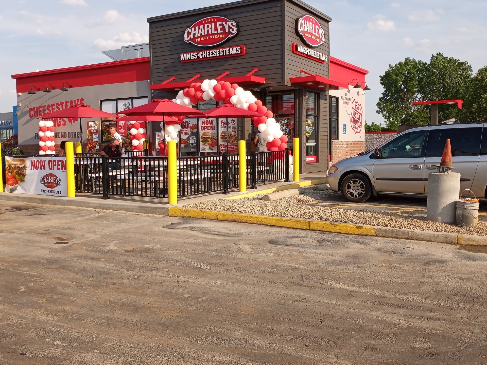 A car is parked in front of a charly 's restaurant