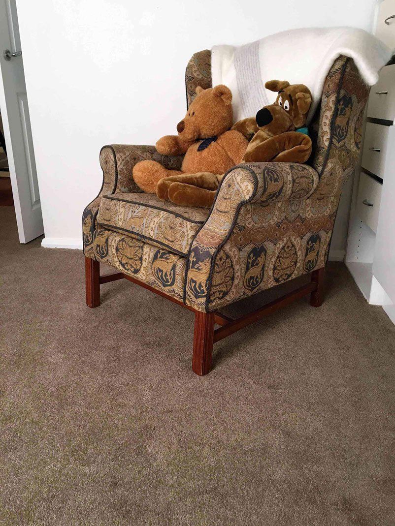 brown floor with brown chair and teddy bear