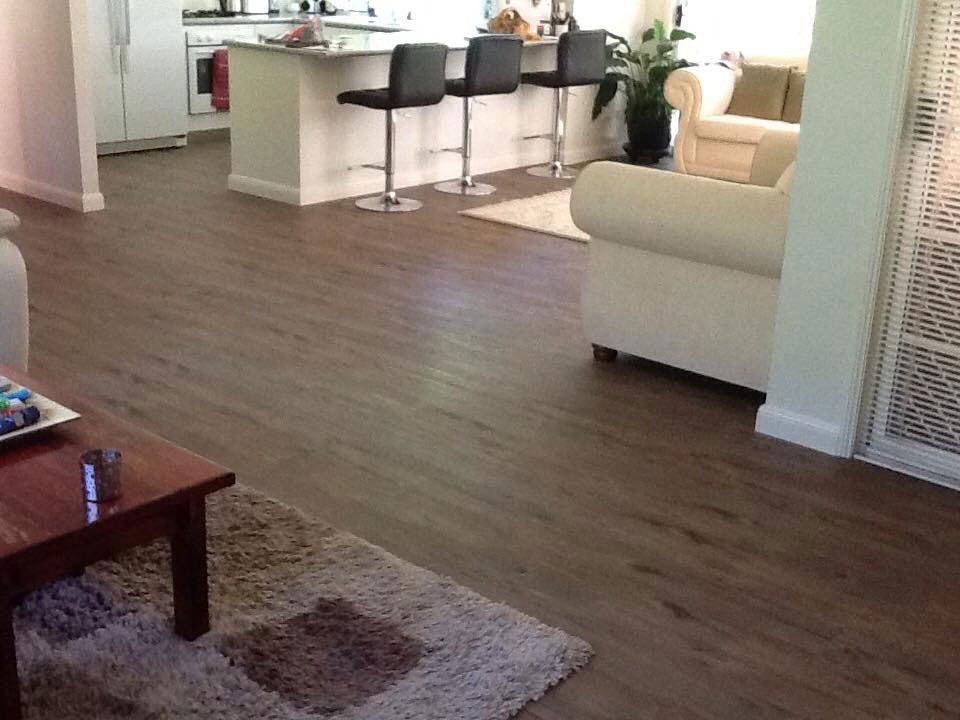 brown floor with white sofa
