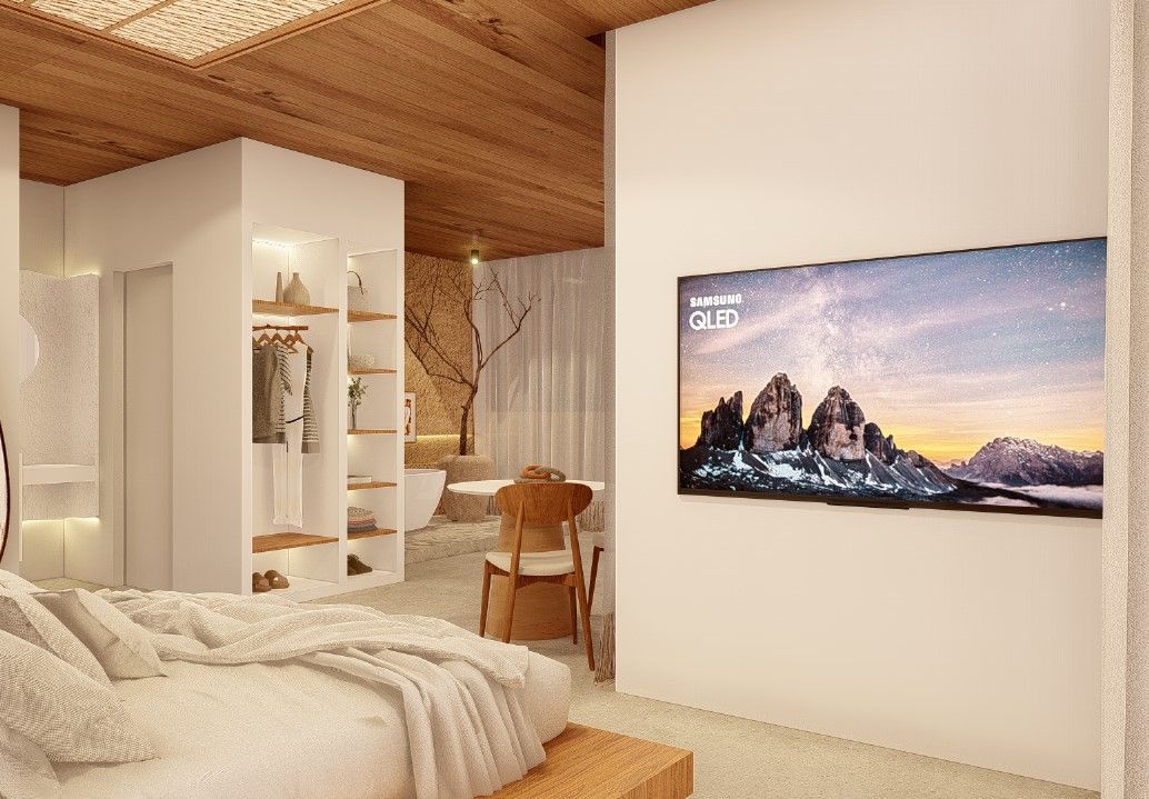 Um quarto com uma cama e uma televisão na parede.