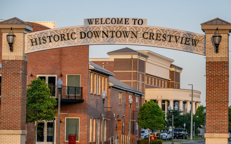 A decorative archway over a street reads 