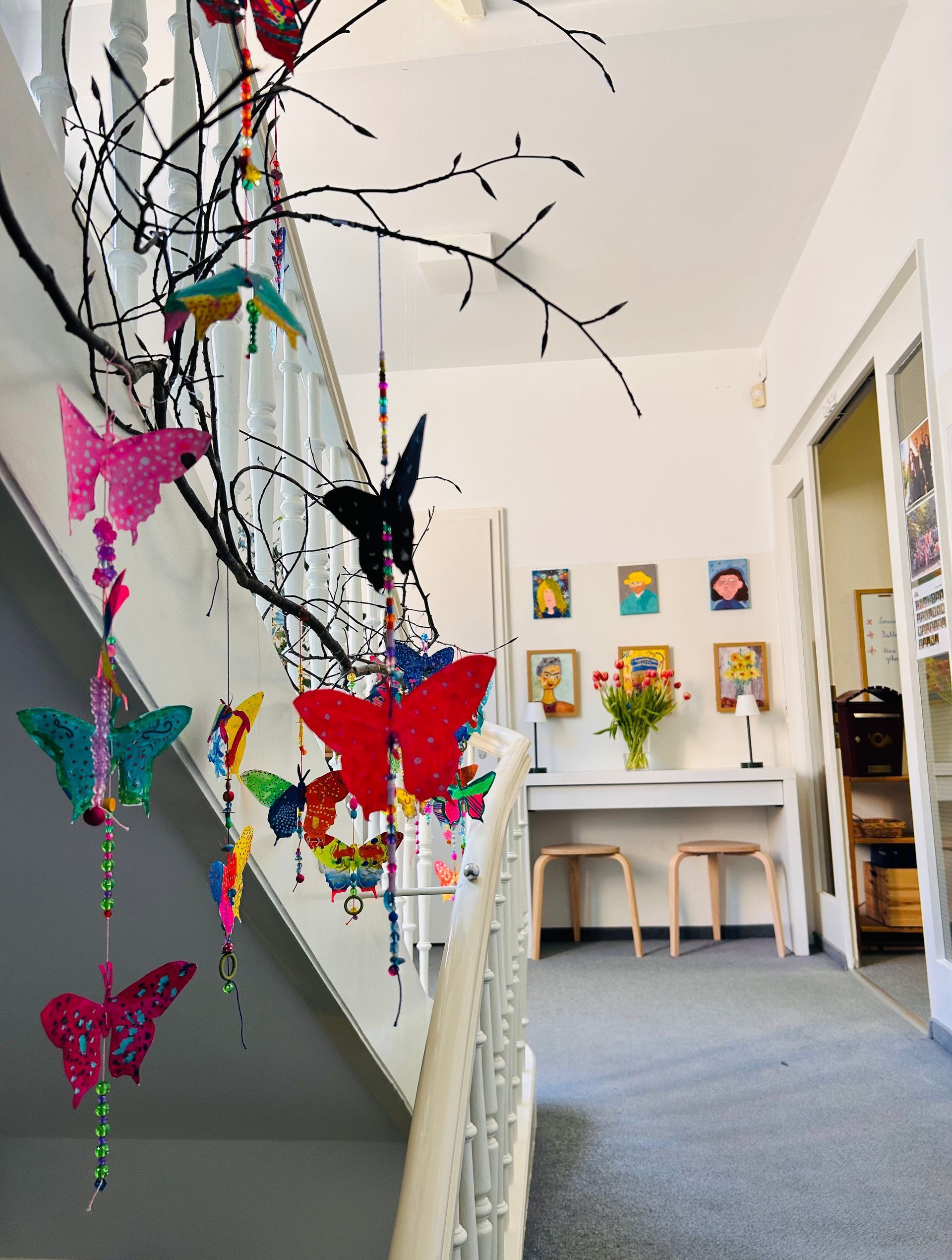 A staircase with a bunch of butterflies hanging from it