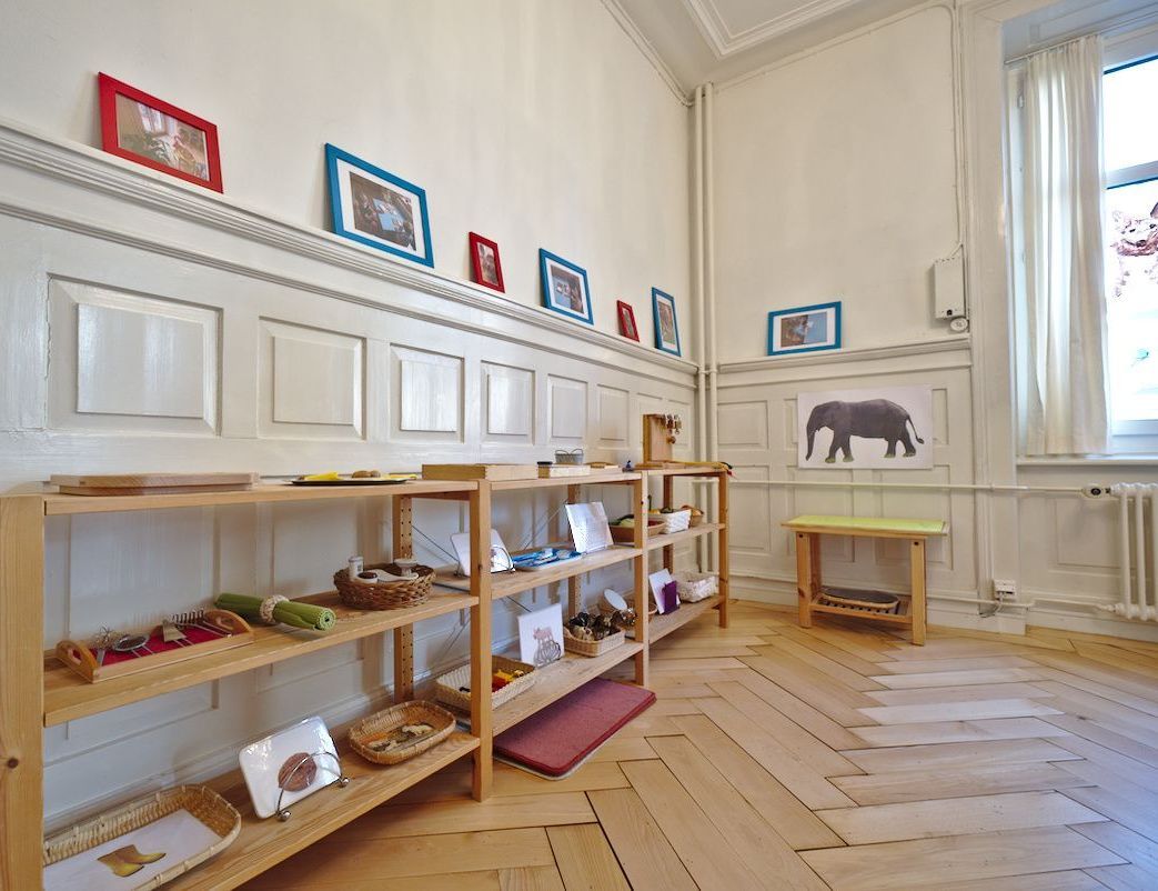 A room with wooden shelves and a picture of an elephant on the wall.