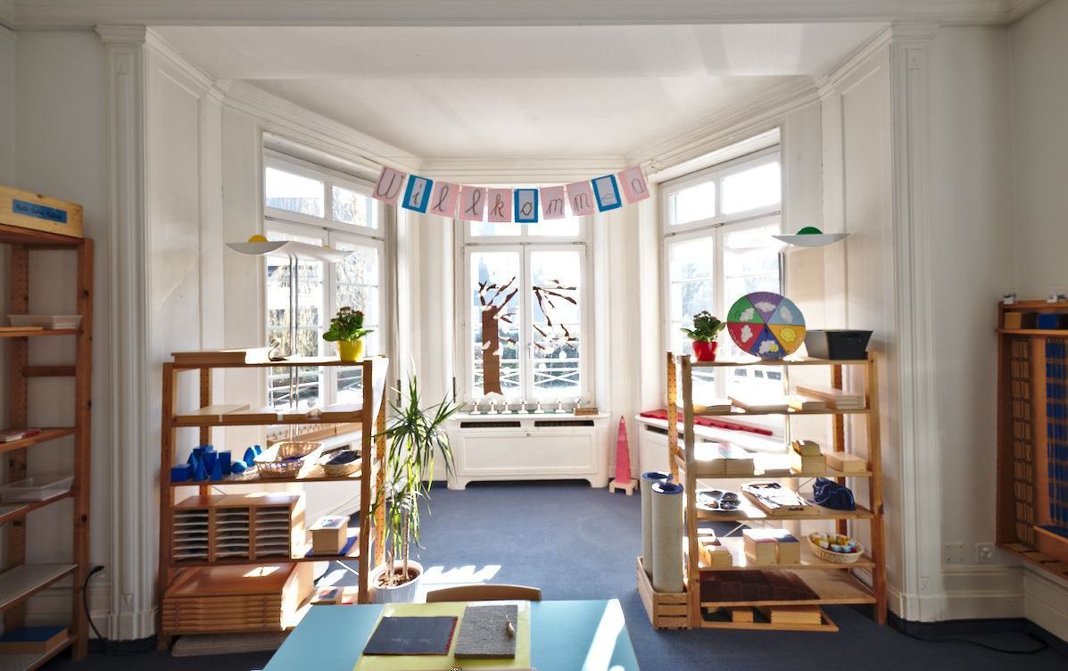 A room with a lot of shelves and a table