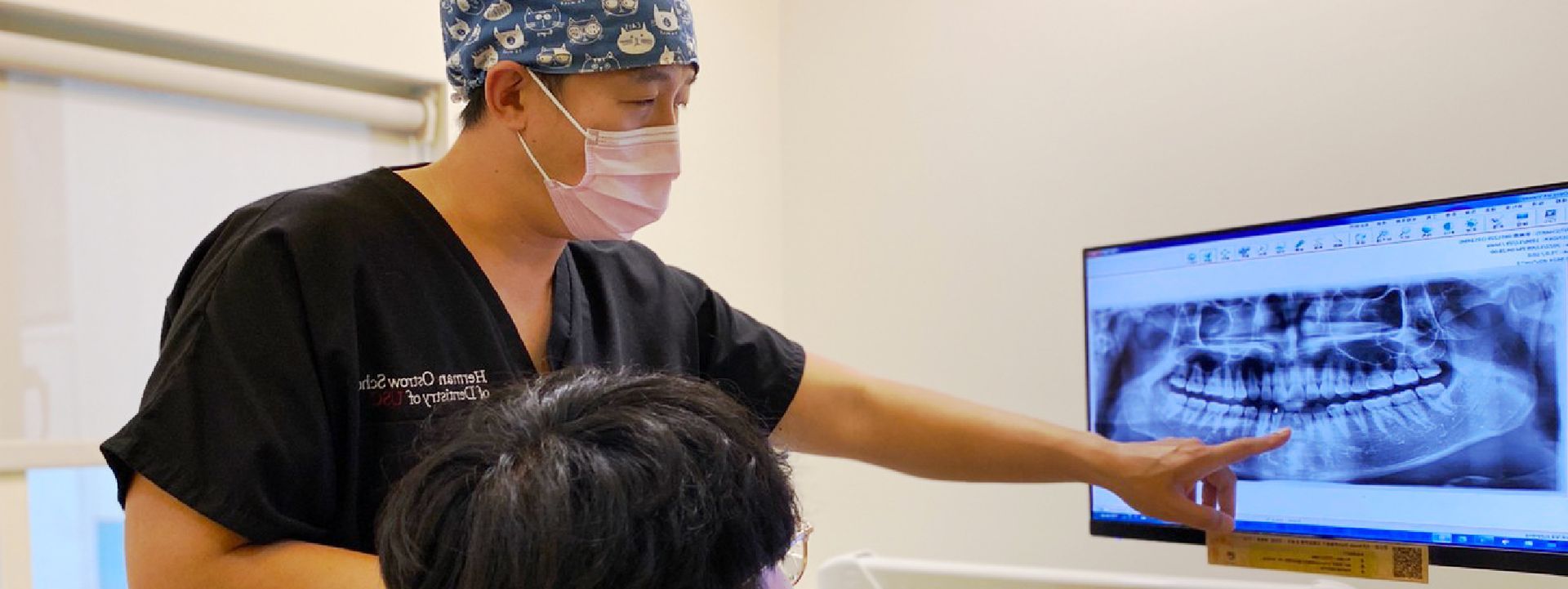 A man wearing a mask is opening a door in a hallway.