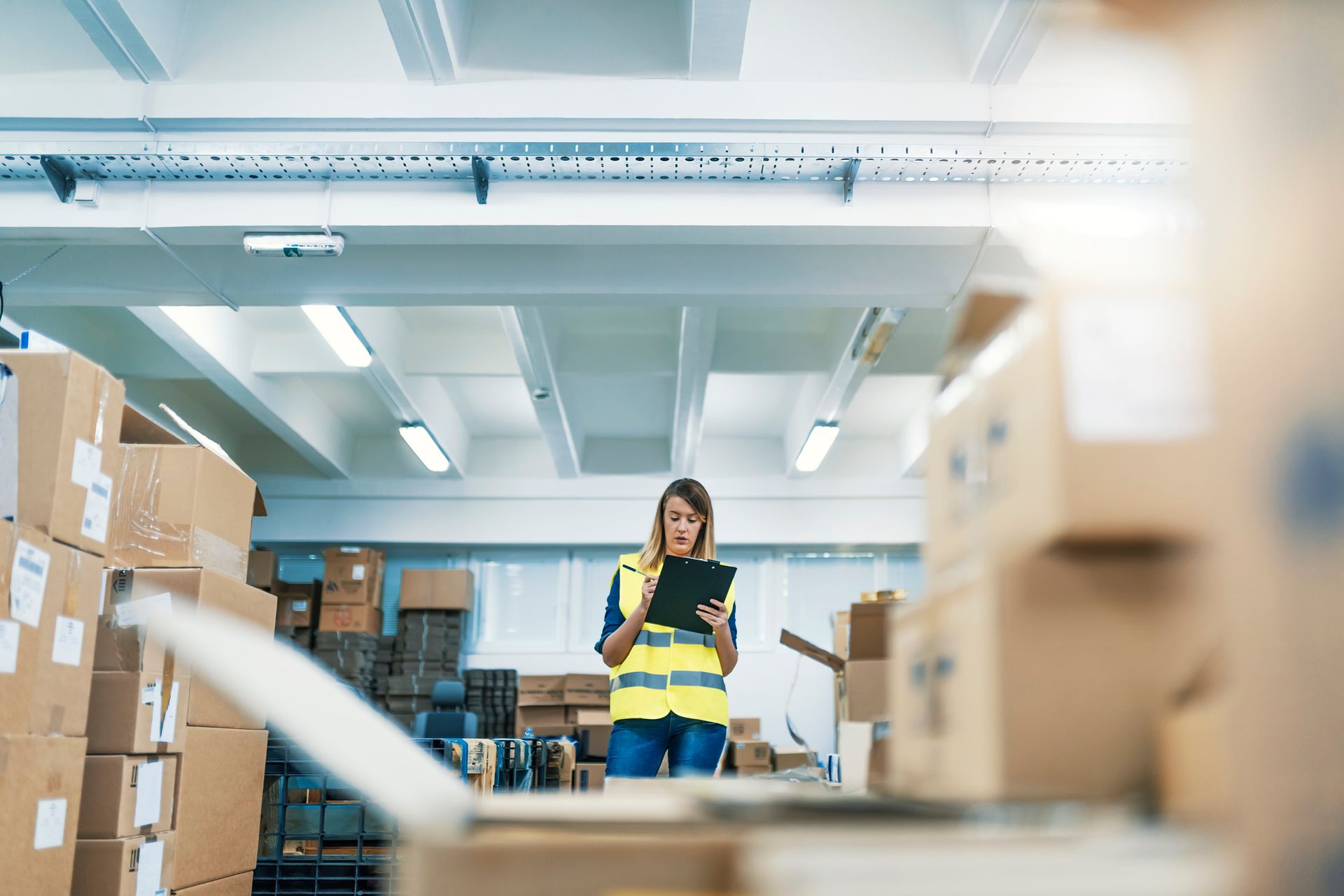 Businesswoman standing in warehouse at RB Logistics offering consolidation services in Alaska
