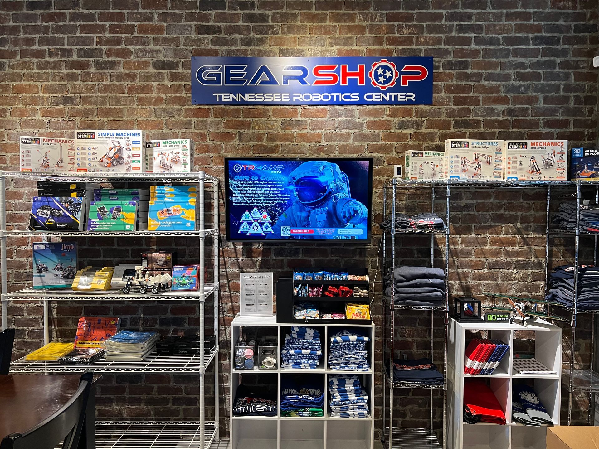 A store filled with lots of toys and a tv on the wall.