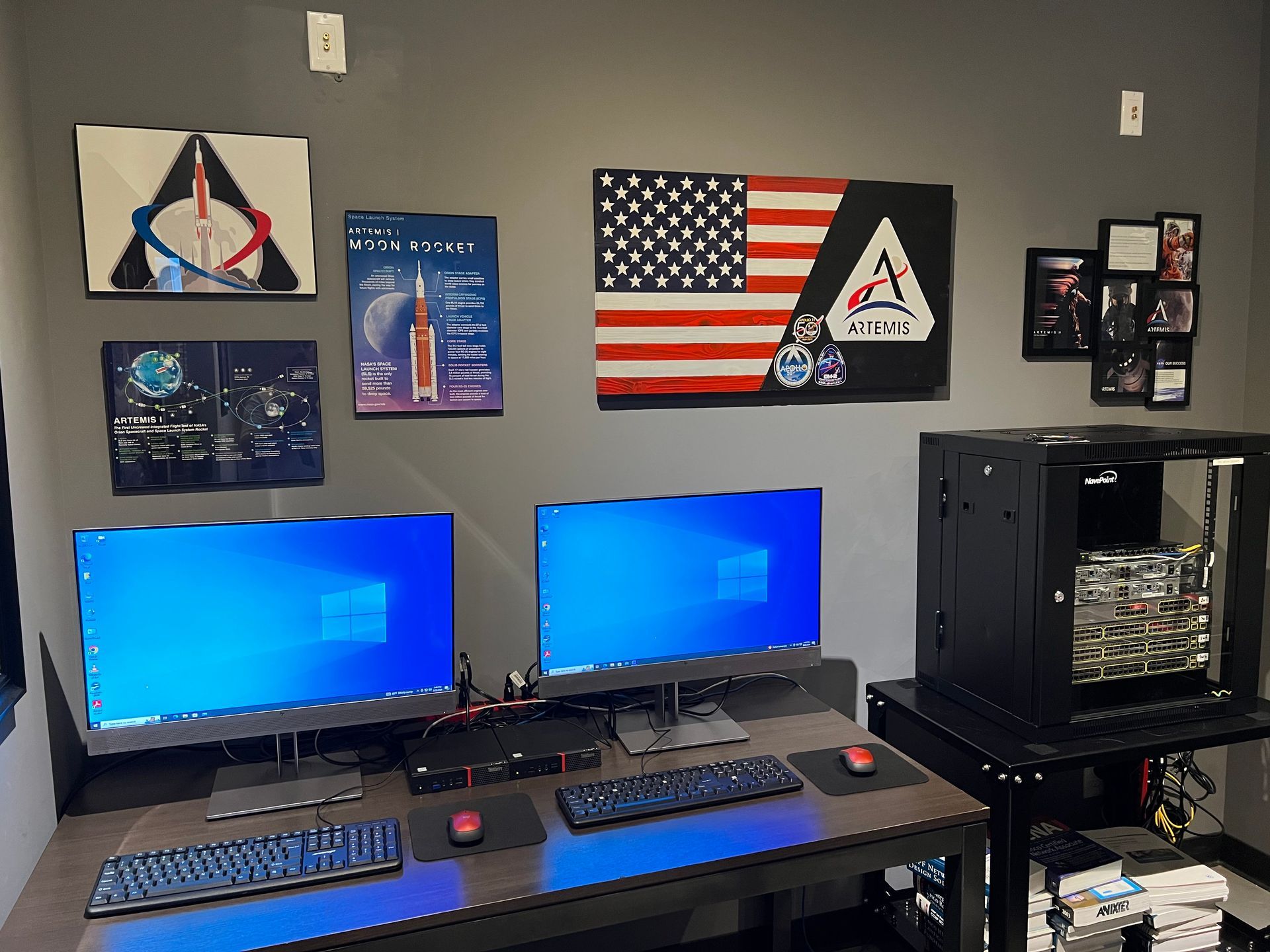 Two computer monitors are sitting on a desk in a room.