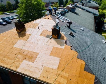 A group of people are working on a roof.