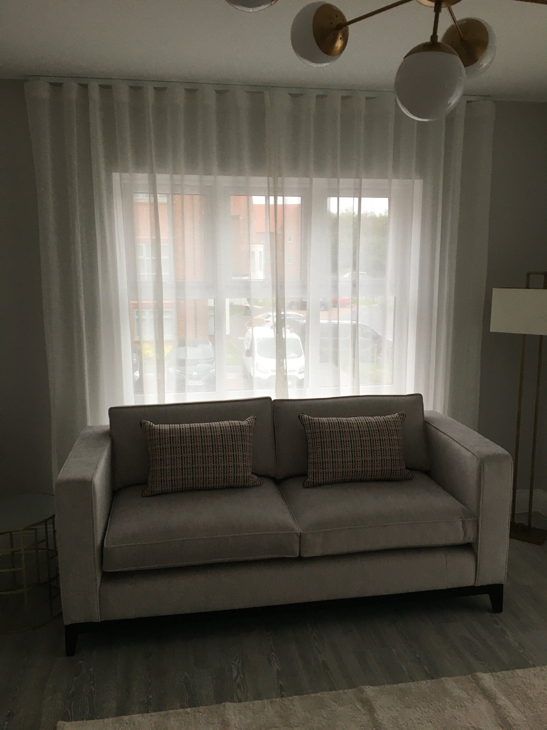 Elegant, thin transparent curtain on the window, by sunlight