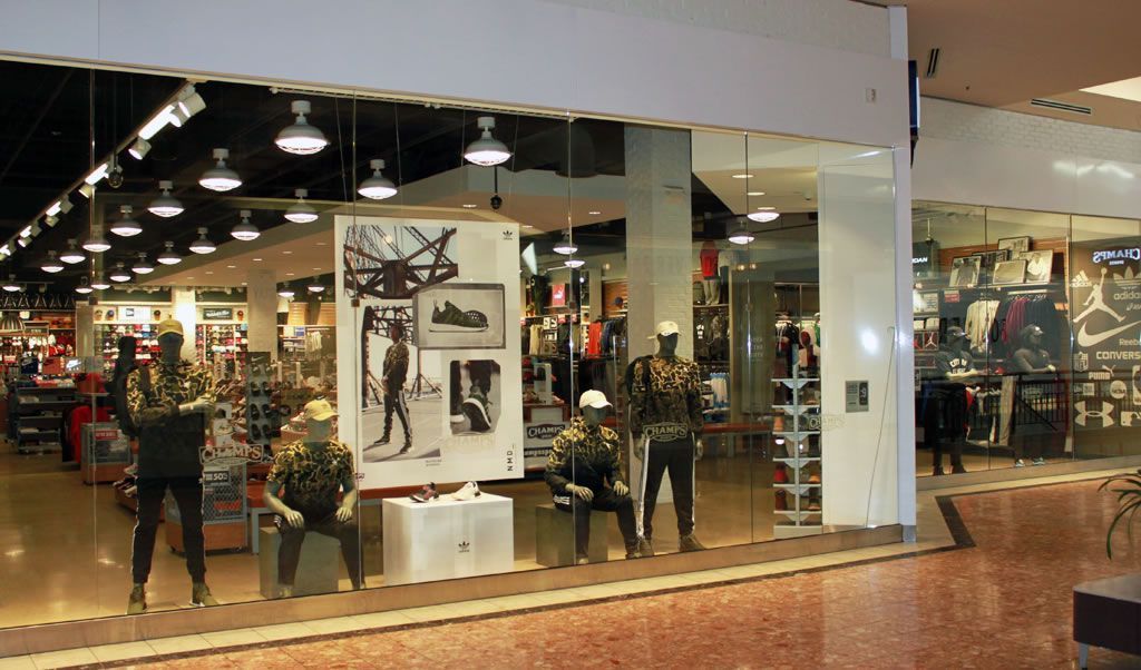 A store with a lot of mannequins in front of it