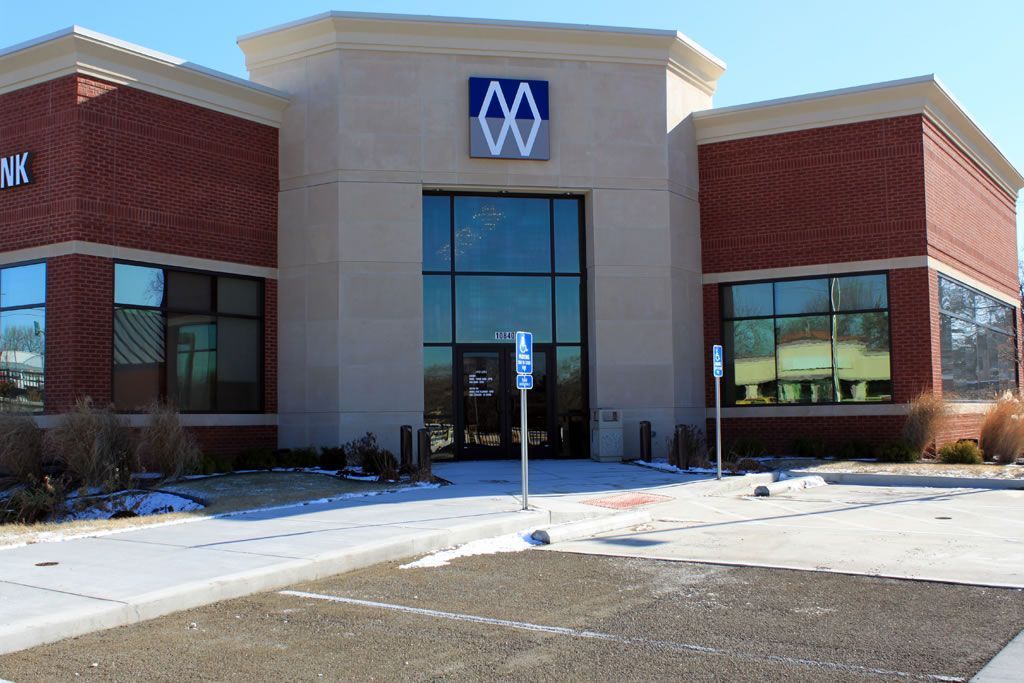 A brick building with a blue sign that says 00 on it