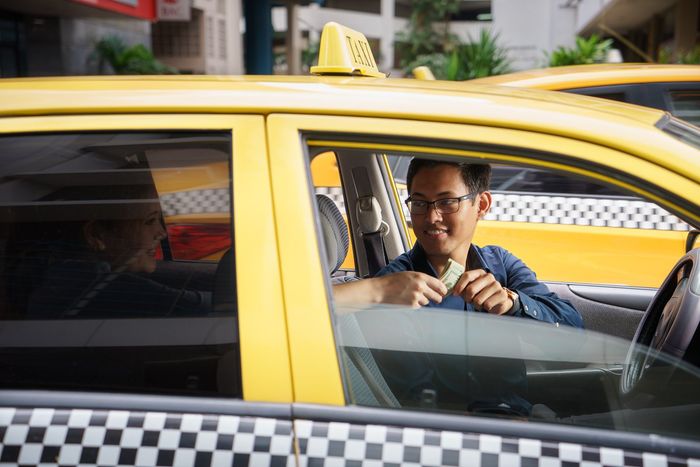 Taxi driver smiling back at passenger