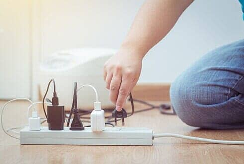 Man Unplugged Plug to Save on Energy — Electrical Services in Saint Paul, MN Man Unplugged Plug to Save on Energy — Electrical Services in Saint Paul, MN