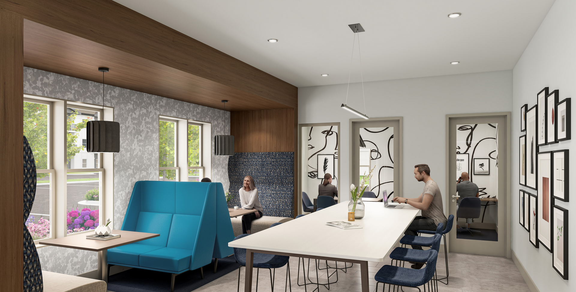 Modern co-working space with blue seating, long table, and two people working.