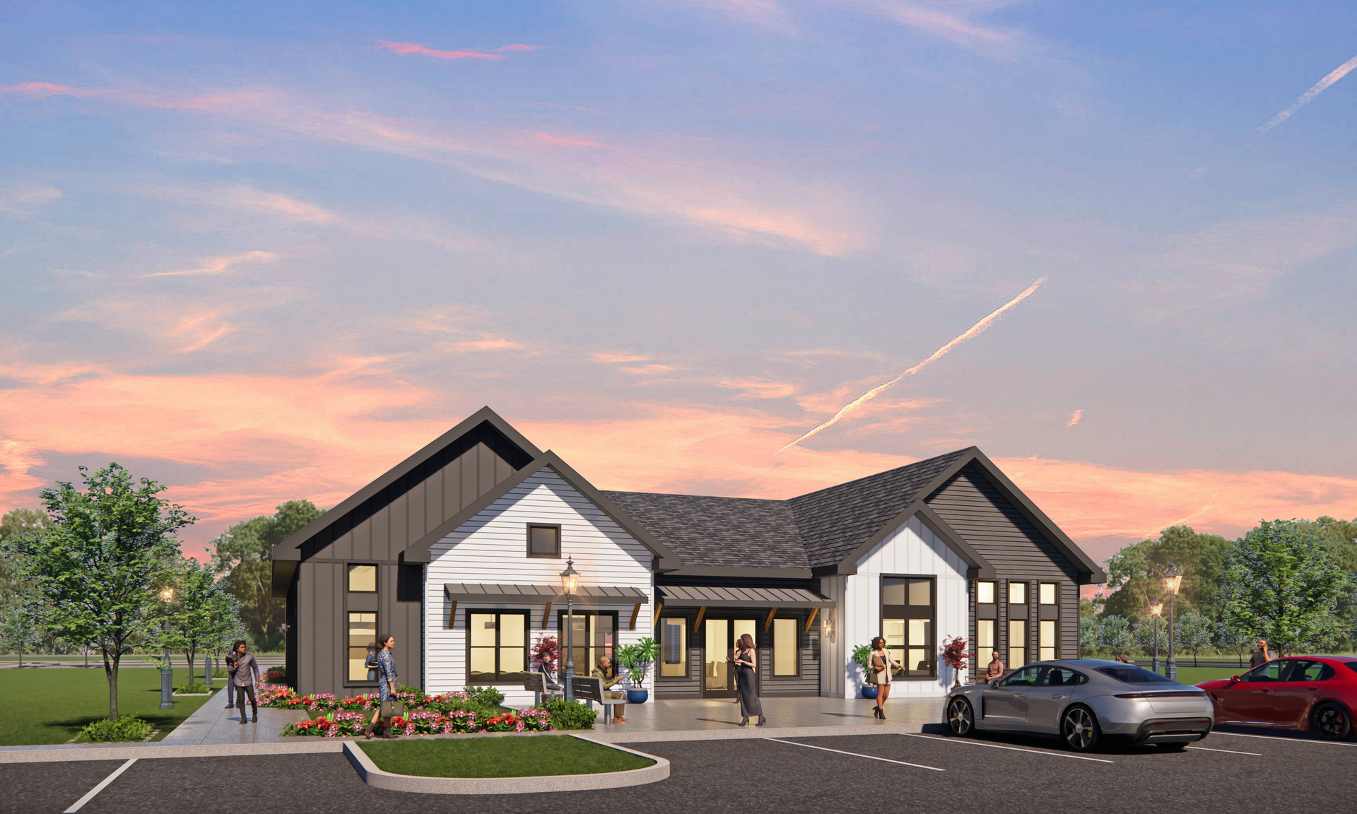 Modern building with white and dark gray accents, with people, parked cars, and a sunset.