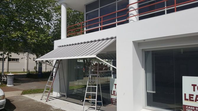 a white building with a awning on the side of it .