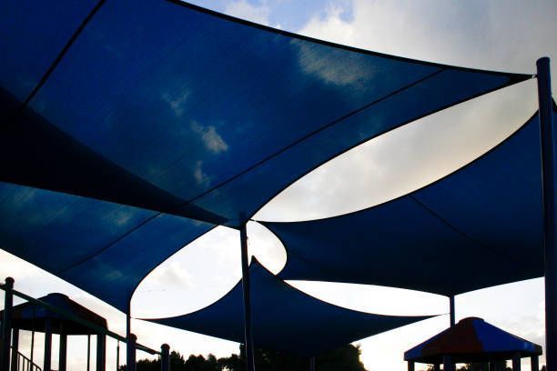 A Blue And White Umbrella With A Playground In The Background - Pukekohe, NZ - Fabritechnics