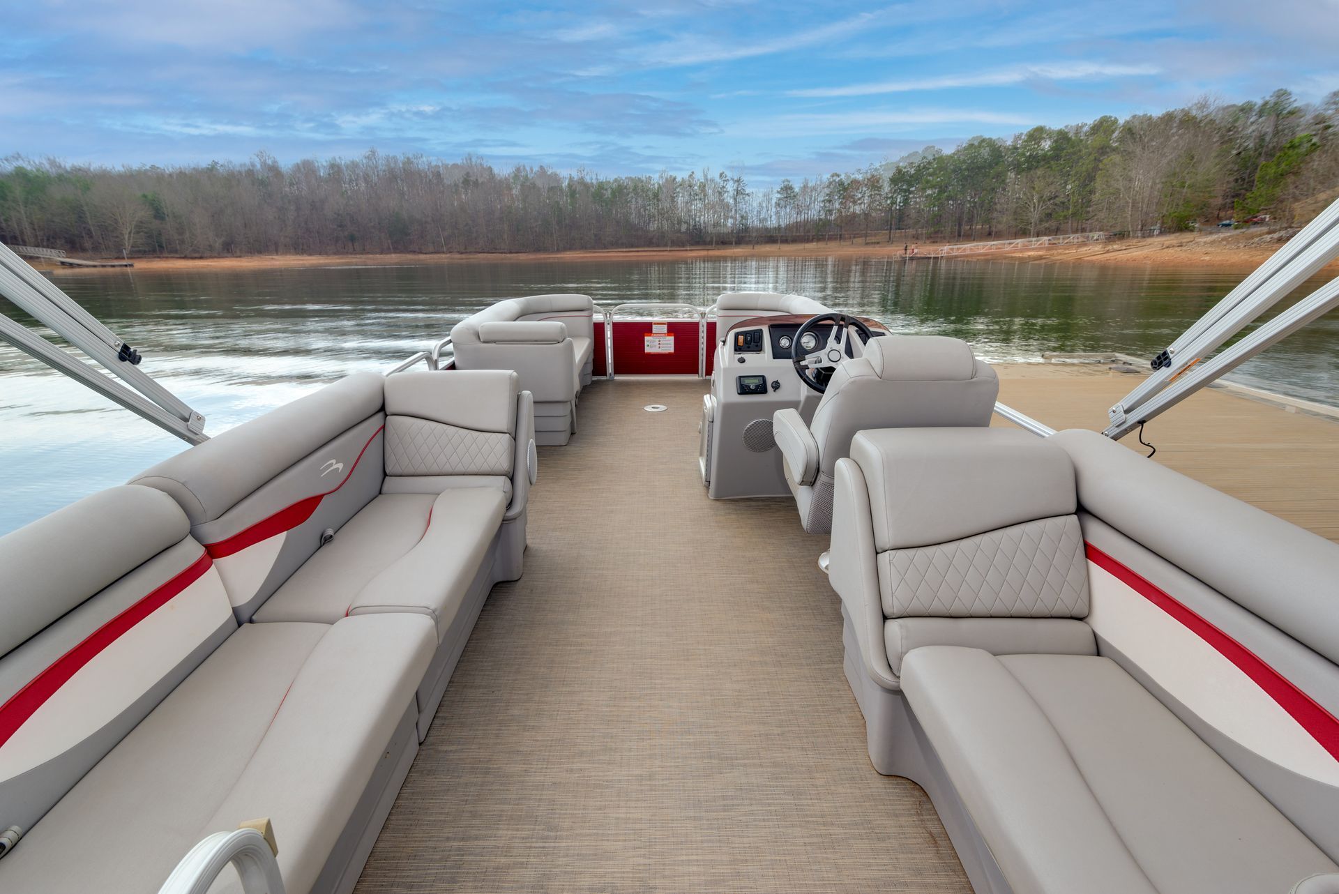 The inside of a pontoon boat on a lake.