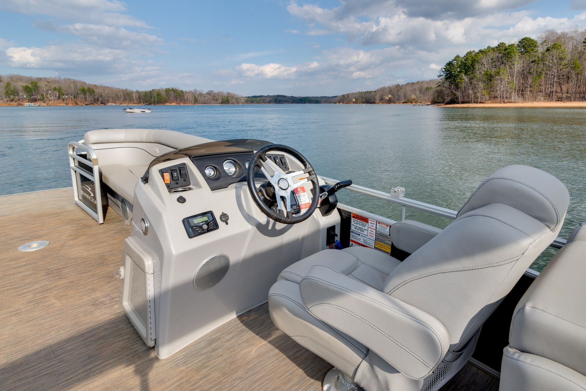 The inside of a pontoon boat on a lake.