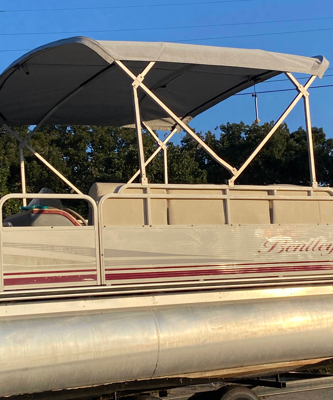 A pontoon boat with a canopy on top of it