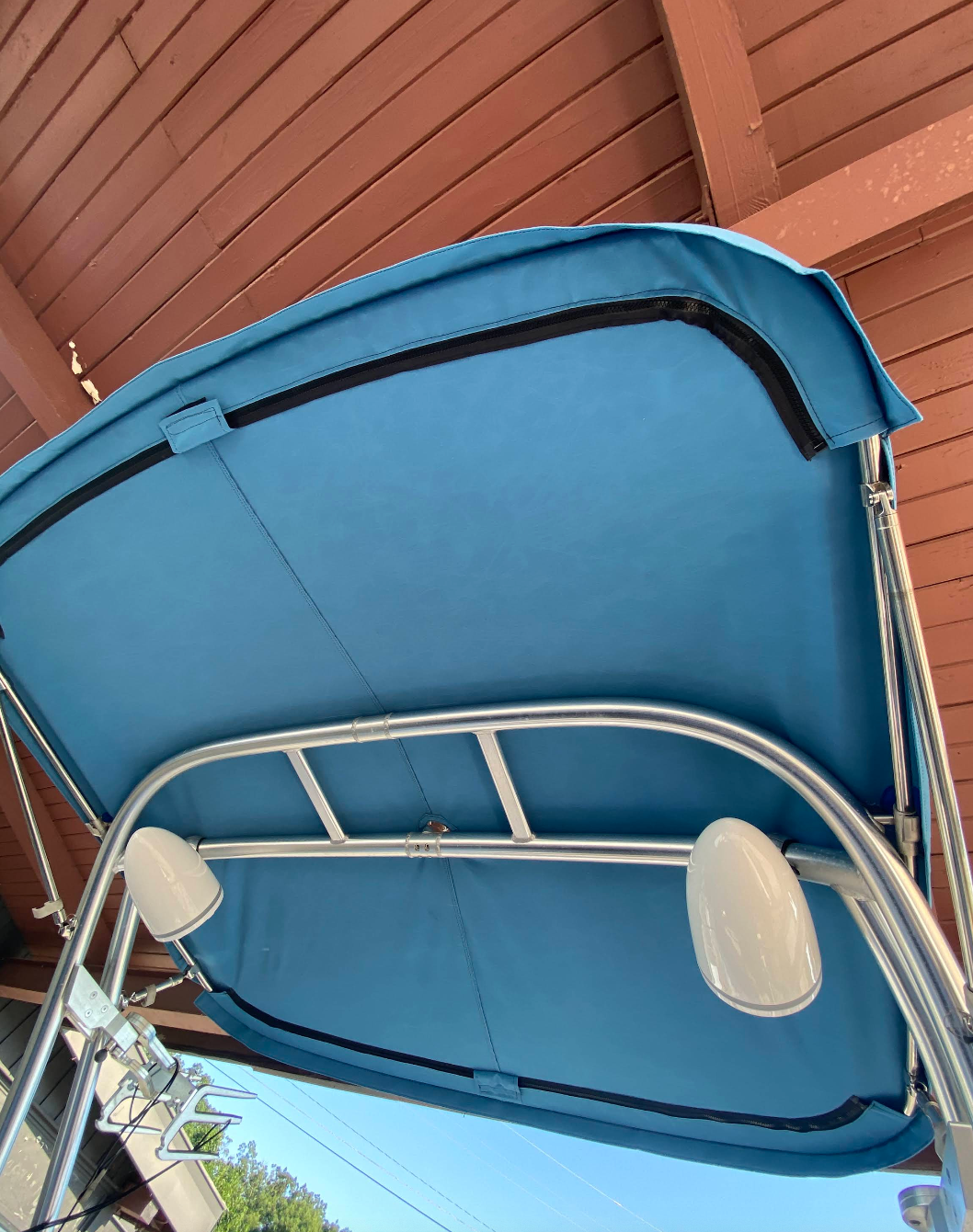 A blue canopy is sitting on top of a boat