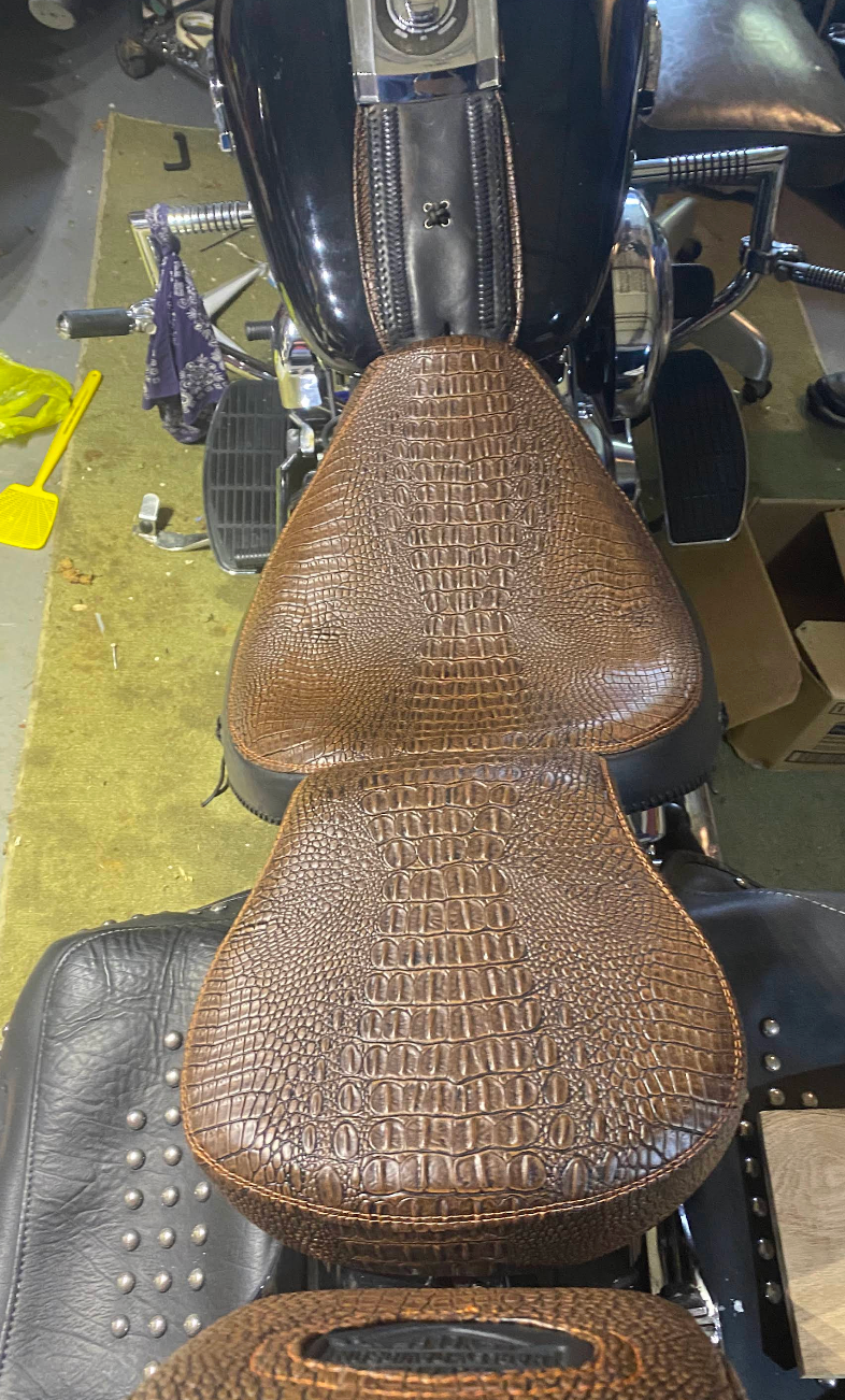 A close up of a motorcycle seat on a table.