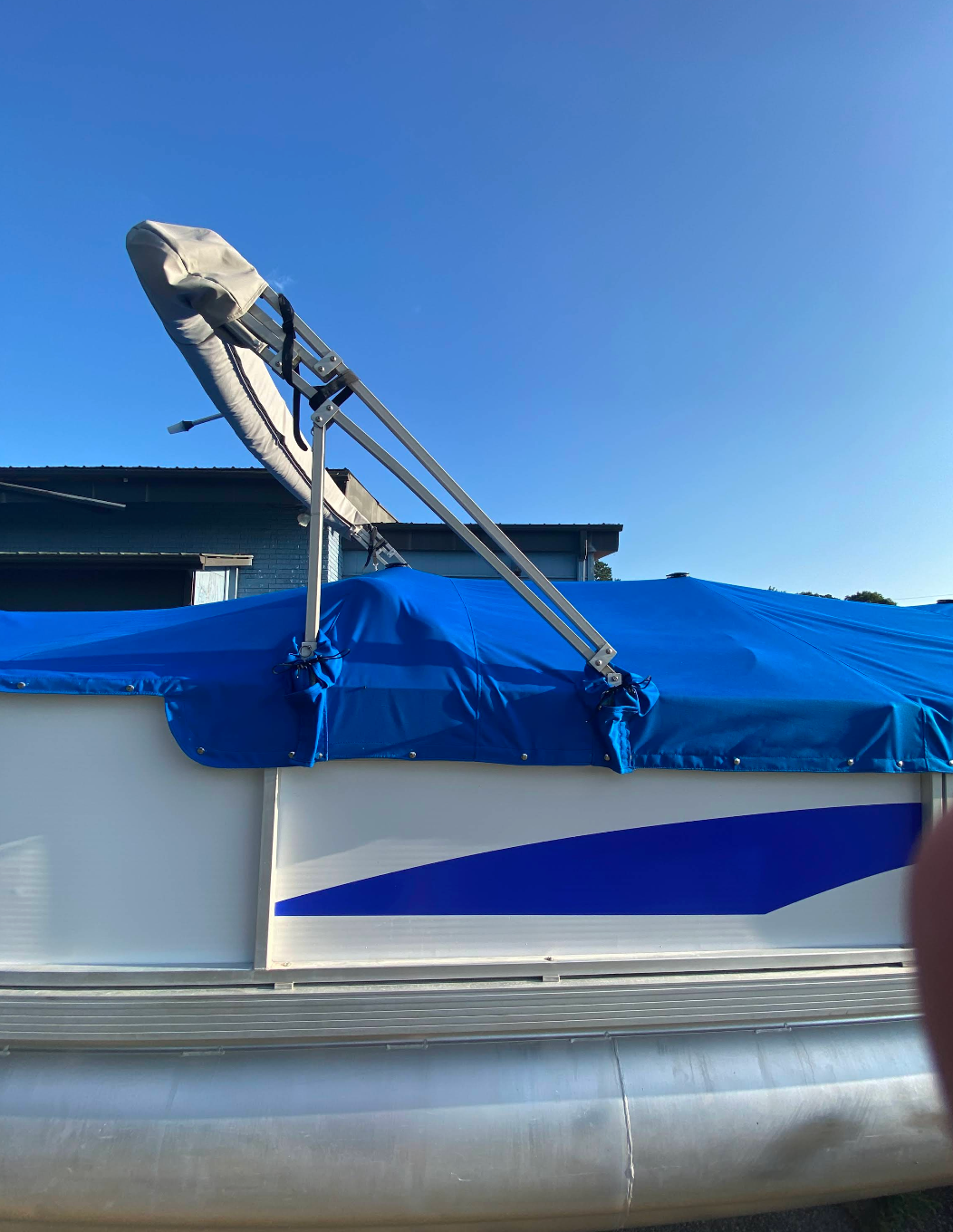 A boat with a blue cover on top of it