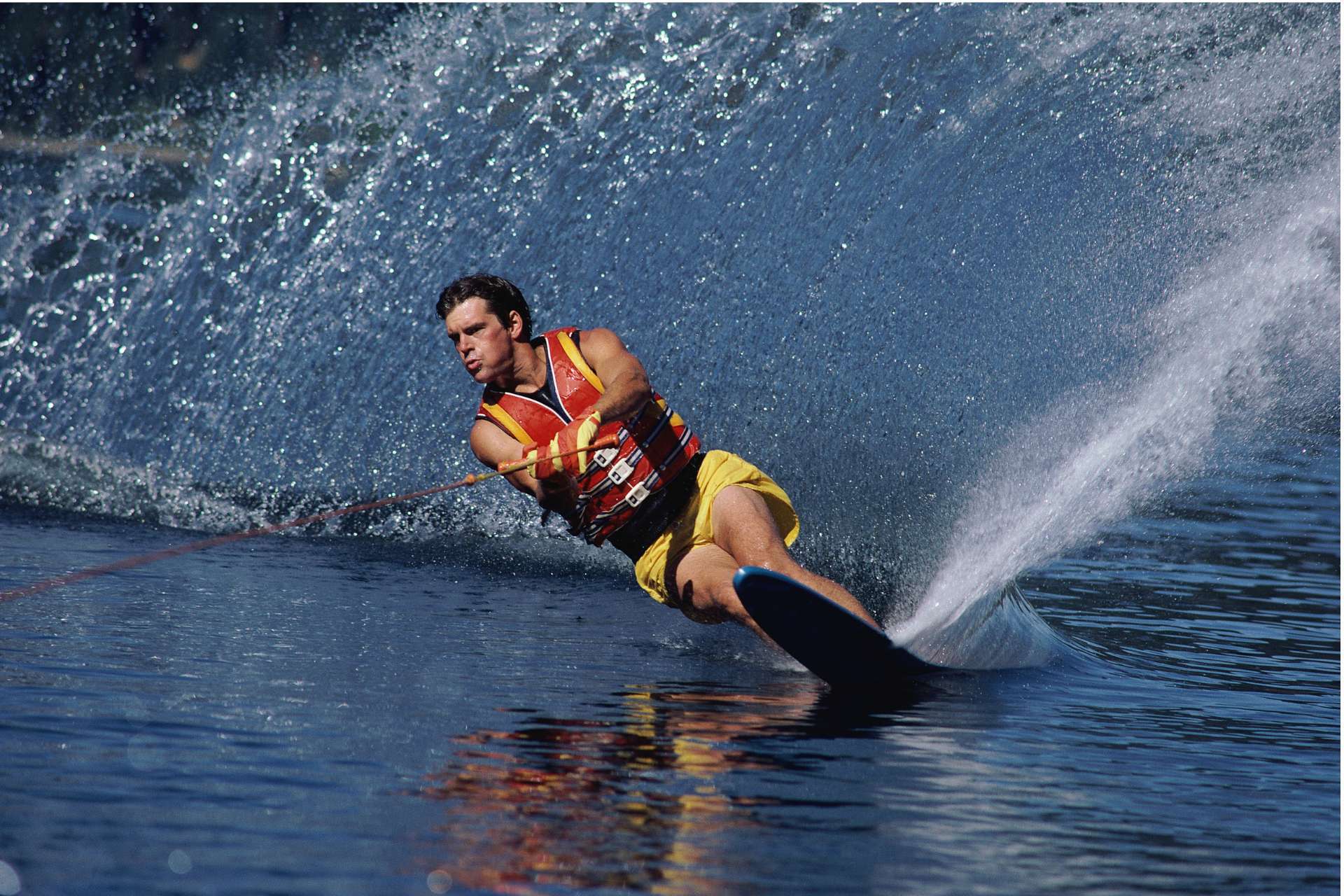 water skiing male pulled by rental boat